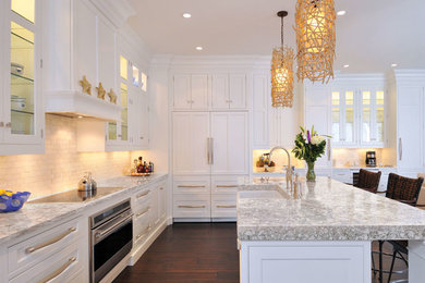 Kitchen - large transitional l-shaped dark wood floor kitchen idea in Seattle with a farmhouse sink, beaded inset cabinets, white cabinets, white backsplash, subway tile backsplash, stainless steel appliances and an island