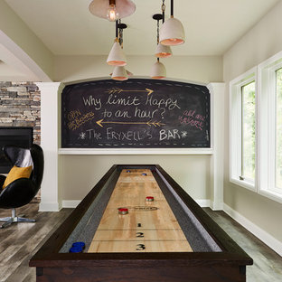 This is an example of a large country walk-out basement in Minneapolis with grey walls, vinyl flooring, a two-sided fireplace, a stone fireplace surround and multi-coloured floors.