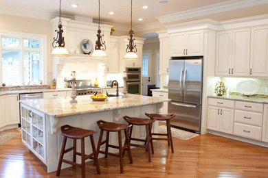 Large elegant l-shaped medium tone wood floor eat-in kitchen photo in Other with raised-panel cabinets, white cabinets, granite countertops, stainless steel appliances and an island