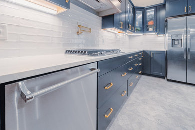 Inspiration for a large contemporary porcelain tile and blue floor eat-in kitchen remodel in Dallas with shaker cabinets, blue cabinets, quartz countertops, white backsplash, subway tile backsplash, stainless steel appliances, an island, white countertops and a single-bowl sink