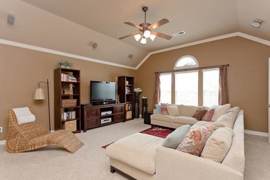 Large minimalist enclosed carpeted and white floor home theater photo in Houston with beige walls and a media wall
