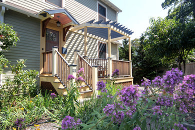 Inspiration for a mid-sized craftsman wood railing front porch remodel in Boston with an awning