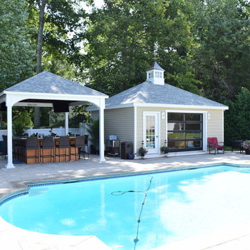 Pool house featuring a french door, glass design, hip roof, and a cupola.