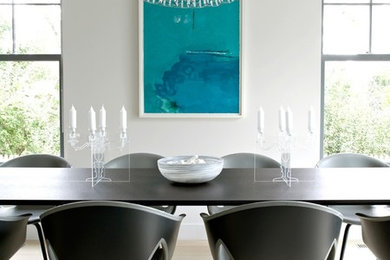Example of a trendy white floor dining room design in Chicago with white walls