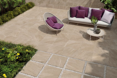 Inspiration for a large contemporary back patio in London with a potted garden and tiled flooring.