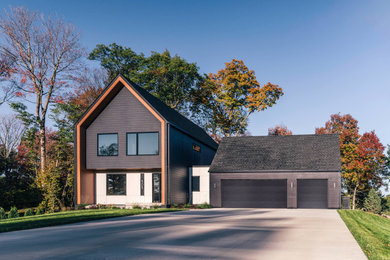 Inspiration for a small scandinavian black two-story mixed siding and clapboard exterior home remodel in Minneapolis with a shingle roof and a black roof