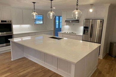 Inspiration for a modern kitchen remodel in Nashville with shaker cabinets, white cabinets and an island