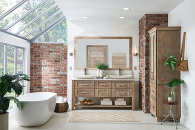 Photo of a large transitional master bathroom with flat-panel cabinets, distressed cabinets and a freestanding tub.