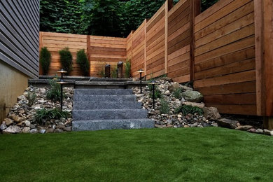 Mid-sized minimalist backyard tile patio photo in Philadelphia with no cover