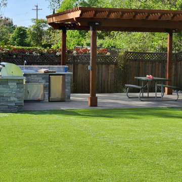 Outdoor kitchen, firepit, pergola, and Synthetic turf