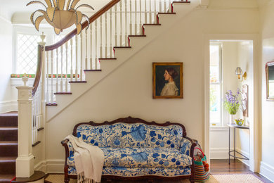 Large ornate medium tone wood floor foyer photo in New York with white walls