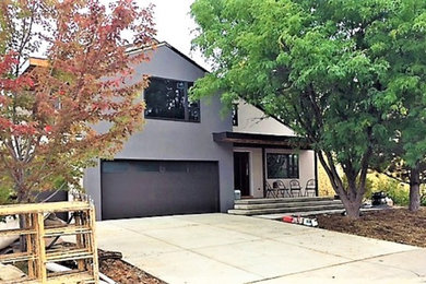 Inspiration for a mid-sized contemporary white two-story stucco exterior home remodel in Denver with a mixed material roof