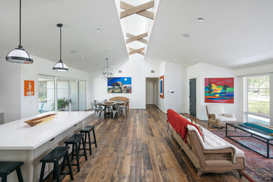 Large dark wood floor and brown floor kitchen/dining room combo photo in Houston with white walls and no fireplace