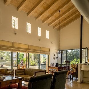 Photo of a medium sized mediterranean formal open plan living room in Tel Aviv with beige walls, slate flooring and a wall mounted tv.