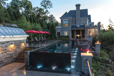 Design ideas for a transitional full sun hillside stone water fountain landscape in Toronto.