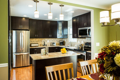 Eat-in kitchen - mid-sized transitional l-shaped medium tone wood floor and brown floor eat-in kitchen idea in DC Metro with an undermount sink, shaker cabinets, dark wood cabinets, granite countertops, multicolored backsplash, matchstick tile backsplash, stainless steel appliances, an island and beige countertops