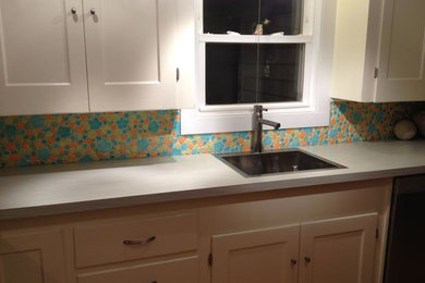 Example of a large trendy l-shaped kitchen design in Portland Maine with ceramic backsplash