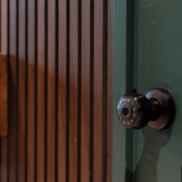Keyless Black Door Knob on Green Door with Wood Slat Wall in Madison Park Playro