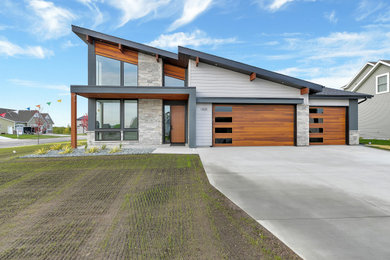 Example of a small minimalist multicolored one-story house exterior design in Minneapolis with a shed roof, a shingle roof and a black roof