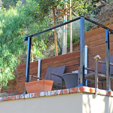 A railed Concrete Deck with brick surround & stucco facing