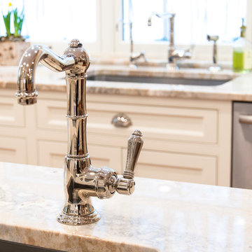 A bar sink on the island with polished nickel fixture