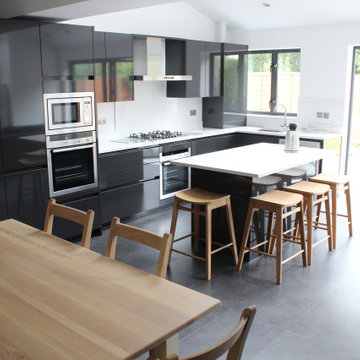 Sleek Modern Black Kitchen with Island by Kudos Interior Design