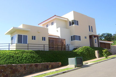 Large contemporary three-storey beige exterior in Other.