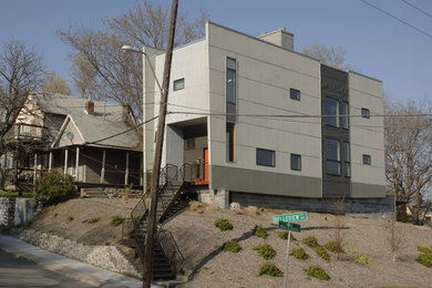 Large modern two-storey grey house exterior in Kansas City with mixed siding and a flat roof.