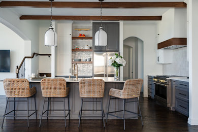 Inspiration for a mid-sized transitional l-shaped dark wood floor, brown floor and exposed beam eat-in kitchen remodel in Dallas with a farmhouse sink, shaker cabinets, gray cabinets, quartzite countertops, white backsplash, ceramic backsplash, stainless steel appliances, an island and white countertops