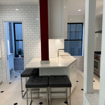 Open Kitchen with White Subway Tile Walls and Custom Cabinetry