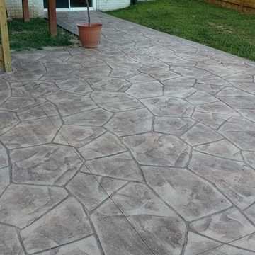 Stamped concrete patio with block seating wall and block fire-pit
