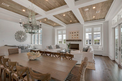 Mid-sized mountain style medium tone wood floor and beige floor kitchen/dining room combo photo in Miami with white walls and a standard fireplace