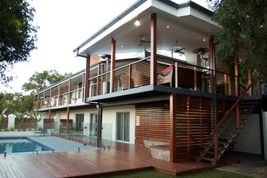 Photo of a large contemporary deck in Brisbane with a roof extension.
