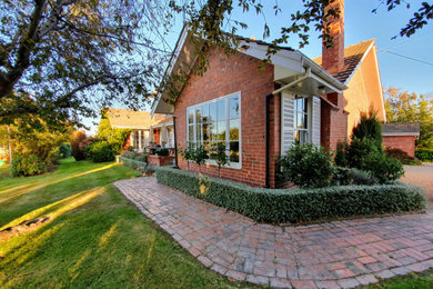 Elegant red two-story brick exterior home photo