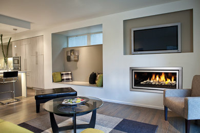 This is an example of a large contemporary open concept living room in Melbourne with grey walls, medium hardwood floors, a ribbon fireplace, a metal fireplace surround and a wall-mounted tv.