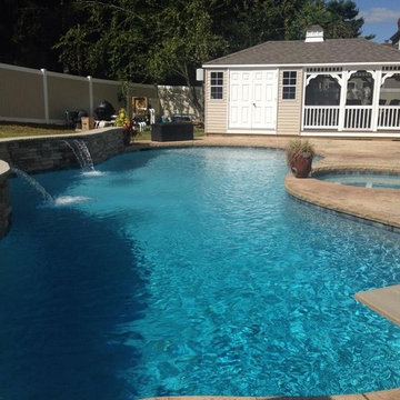 Freeform style in-ground pool with spa and diving board
