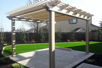 Design ideas for a small backyard patio in Sacramento with a pergola.