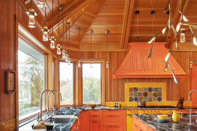 Example of a huge eclectic vaulted ceiling kitchen design in Burlington with an undermount sink, beaded inset cabinets, orange cabinets, colored appliances and an island