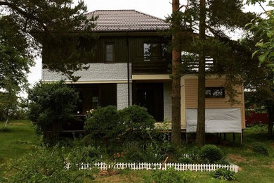 Пример оригинального дизайна: двухэтажный, коричневый частный загородный дом среднего размера в современном стиле с комбинированной облицовкой, вальмовой крышей и металлической крышей