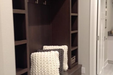 Mid-sized elegant porcelain tile and gray floor mudroom photo in Other with white walls