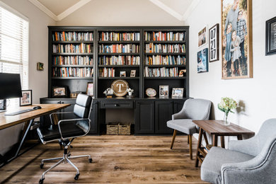 Home office library - mid-sized transitional freestanding desk vinyl floor home office library idea in Dallas with beige walls