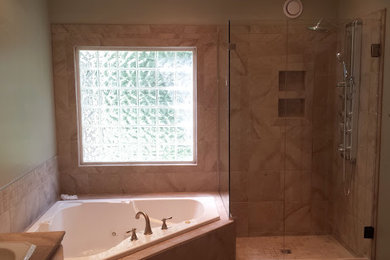 Inspiration for a mid-sized transitional master beige tile and porcelain tile bathroom remodel in Atlanta with beige walls, a drop-in sink and a hinged shower door