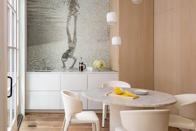 Inspiration for a mid-sized contemporary medium tone wood floor and brown floor kitchen/dining room combo remodel in Boston with multicolored walls and no fireplace