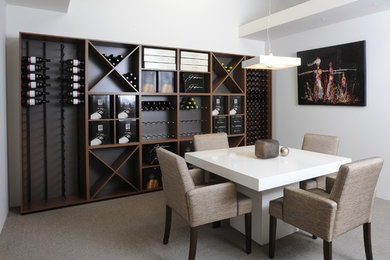 Design ideas for a mid-sized contemporary wine cellar in Adelaide with carpet and storage racks.