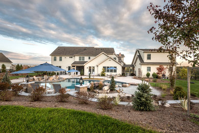 Inspiration for a large transitional beige three-story mixed siding exterior home remodel in Other