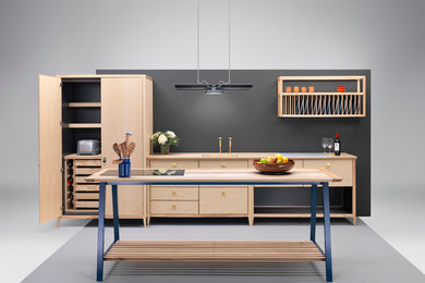 Photo of a medium sized scandinavian single-wall open plan kitchen in Other with an integrated sink, flat-panel cabinets, light wood cabinets, wood worktops, integrated appliances and an island.