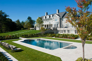 Large traditional gray three-story stone exterior home idea in New York with a shingle roof