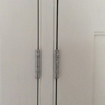 Wardrobe with internal rails and shelving, built into alcove