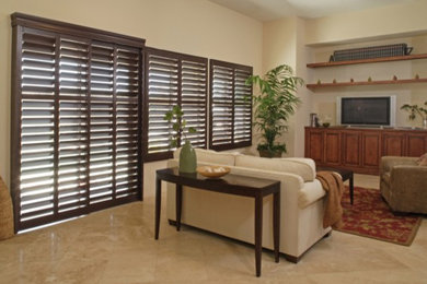 Living room - mid-sized open concept travertine floor living room idea in Huntington with beige walls and a media wall