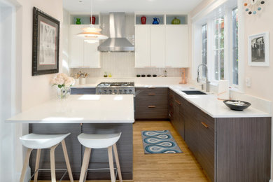 Inspiration for a mid-sized 1950s l-shaped light wood floor and brown floor eat-in kitchen remodel in DC Metro with an undermount sink, flat-panel cabinets, dark wood cabinets, quartz countertops, white backsplash, subway tile backsplash, paneled appliances, a peninsula and white countertops
